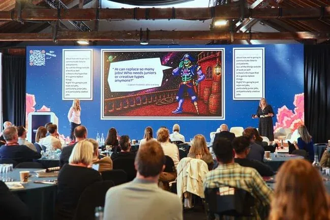 Attendees watching a presentation at Adventures in Pharma