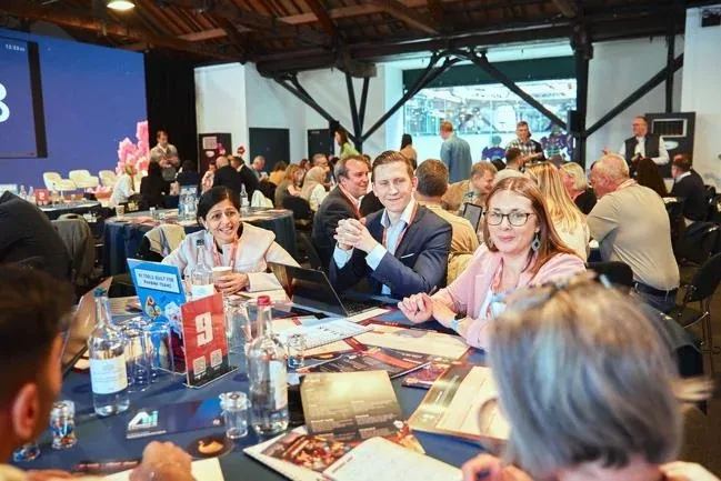 Attendees discussing ideas around a table at Adventures in Pharma