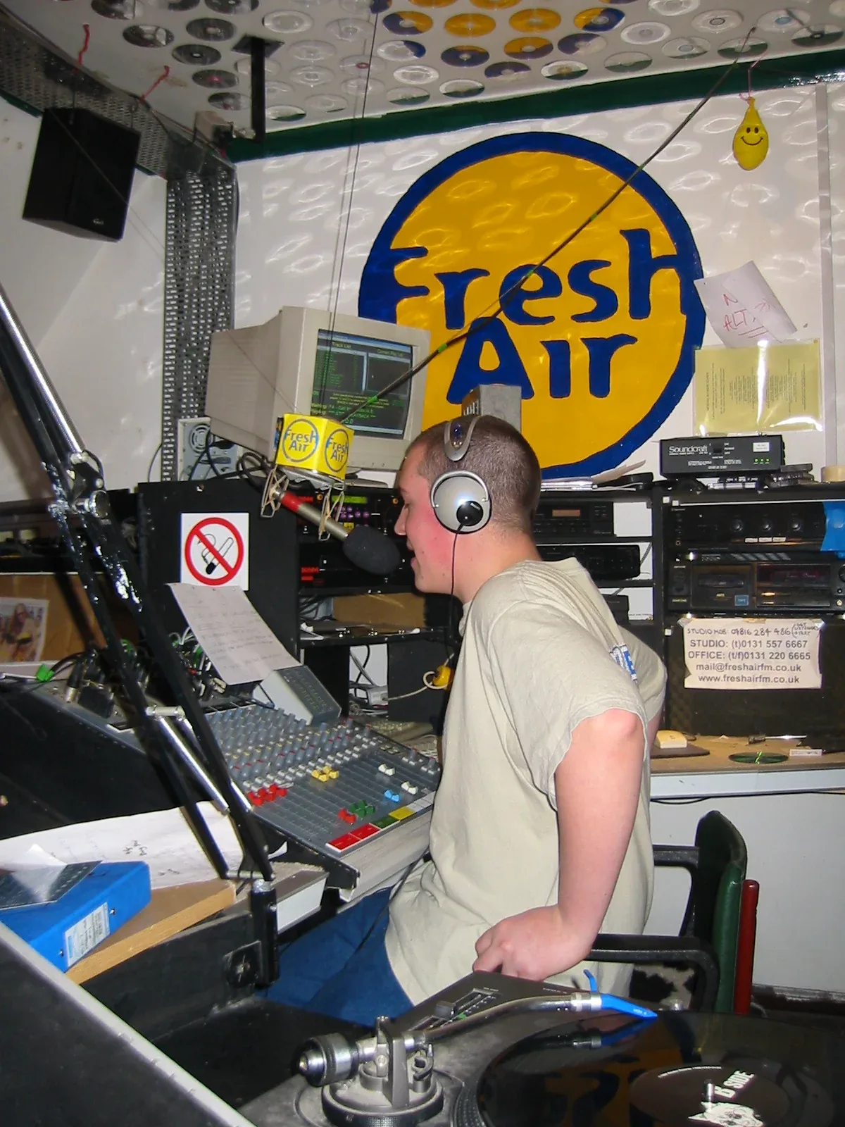 James Turnbull wearing headphones at the microphone in the Fresh Air student radio studio